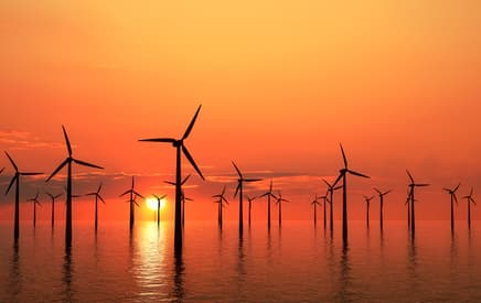 A wind farm at sunset is quite inspiring A wind farm at sunset is quite inspiring